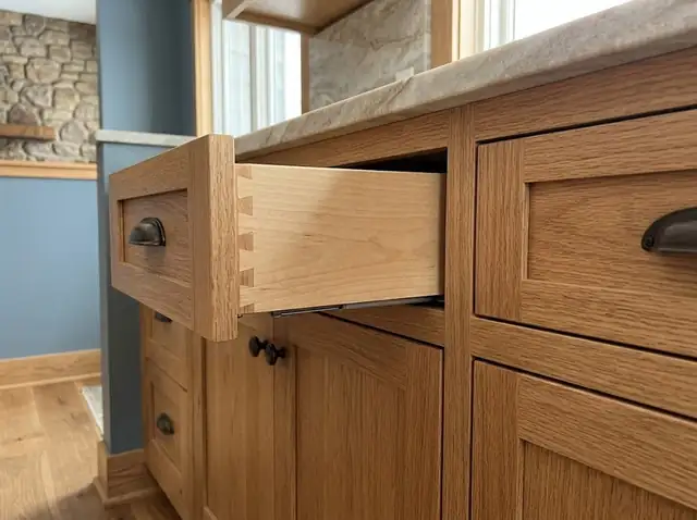 Illustration of custom oak kitchen cabinet doors and an open dovetailed drawer